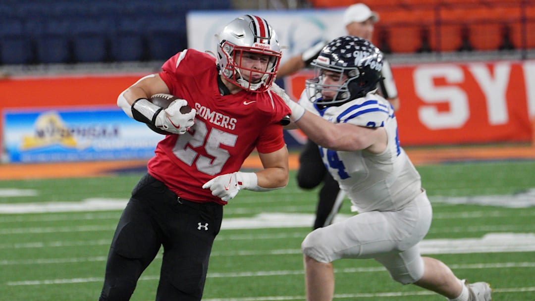 Somers' Mason Kelly (25) looks for some running room in the Whitesboro defense during the Class A NYSPHSAA football championship at the JMA Wireless Dome in Syracuse, New York Dec. 6, 2024.