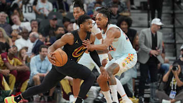 Apr 4, 2025; San Antonio, Texas, USA;  Cleveland Cavaliers guard Donovan Mitchell (45) dribbles against San Antonio Spurs guard Devin Vassell (24) in the second half at Frost Bank Center. Mandatory Credit: Daniel Dunn-Imagn Images