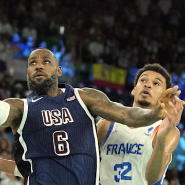 Aug 10, 2024; Paris, France; United States guard LeBron James (6) shoots against France power forward Victor Wembanyama (32) in the first half in the men's basketball gold medal game during the Paris 2024 Olympic Summer Games at Accor Arena. 