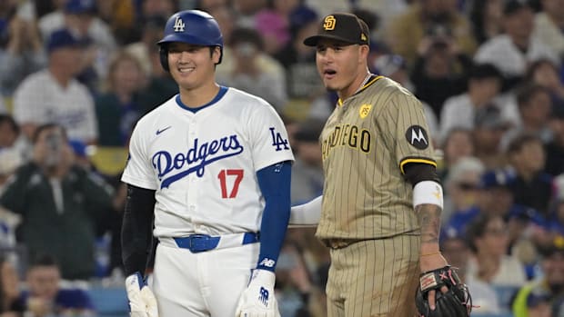 Los Angeles Dodgers designated hitter Shohei Ohtani and San Diego Padres third baseman Manny Machado talk on the base.