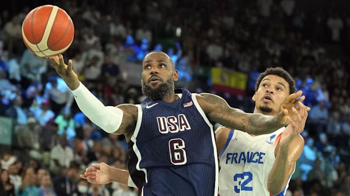 Aug 10, 2024; Paris, France; United States guard LeBron James (6) shoots against France power forward Victor Wembanyama (32) in the first half in the men's basketball gold medal game during the Paris 2024 Olympic Summer Games at Accor Arena. 