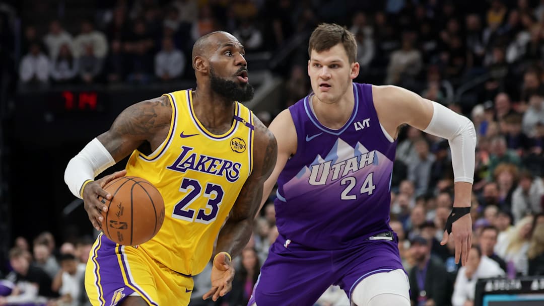 Feb 12, 2025; Salt Lake City, Utah, USA;  Los Angeles Lakers forward LeBron James (23) dribbles past Utah Jazz center Walker Kessler (24) during the first quarter at Delta Center. Mandatory Credit: Chris Nicoll-Imagn Images