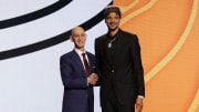 Kel'el Ware poses for photos with NBA commissioner Adam Silver after being selected in the first round by the Miami Heat.