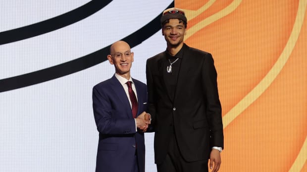 Kel'el Ware poses for photos with NBA commissioner Adam Silver after being selected in the first round by the Miami Heat in t