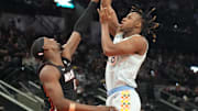 Feb 1, 2025; San Antonio, Texas, USA: San Antonio Spurs center Charles Bassey (28) shoots over Miami Heat center Bam Adebayo (13) during the first half at Frost Bank Center. Mandatory Credit: Scott Wachter-Imagn Images