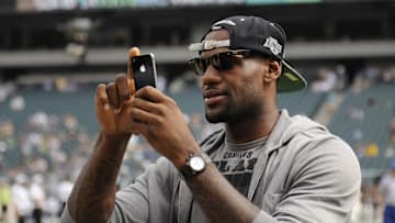 Sep 25, 2011; Philadelphia, PA, USA; Professional basketball player LeBron James takes pictures with his camera phone along the Philadelphia Eagles sideline prior to the game against the New York Giants at Lincoln Financial Field. Mandatory Credit: Howard Smith-Imagn Images