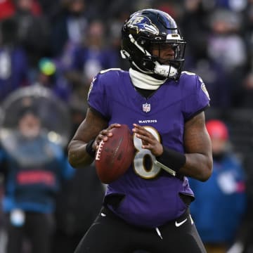 Jan 20, 2024; Baltimore, MD, USA; Baltimore Ravens quarterback Lamar Jackson (8) drops back to throw against the Houston Texans in the first quarter of a 2024 AFC divisional round game at M&T Bank Stadium. Mandatory Credit: Tommy Gilligan-USA TODAY Sports