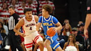 Dec 14, 2024; Phoenix, Arizona, USA; UCLA Bruins guard Trent Perry (1) against Arizona Wildcats forward Trey Townsend (4) at Footprint Center. Mandatory Credit: Mark J. Rebilas-Imagn Images