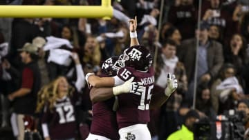 Nov 26, 2022; College Station, Texas, USA; Texas A&M Aggies quarterback Conner Weigman (15) and offensive lineman Layden Robinson (64) celebrates a touchdown against the LSU Tigers during the second half at Kyle Field. Mandatory Credit: Jerome Miron-USA TODAY Sports
