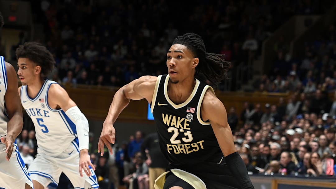 Feb 12, 2024; Durham, North Carolina, USA;  Wake Forest Deamon Deacons guard Hunter Sallis (23) drives to the basket as Duke Blue Devils forward Sean Stewart (13) defends during the first half at Cameron Indoor Stadium. Mandatory Credit: Rob Kinnan-Imagn Images