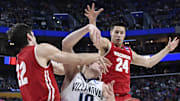Mar 18, 2017; Buffalo, NY, USA; Wisconsin Badgers forward Ethan Happ (22) blocks a shot by Villanova Wildcats guard Donte DiVincenzo (10) as Wisconsin  guard Bronson Koenig (24) backs up the play in the second half during the second round of the 2017 NCAA Tournament at KeyBank Center. Wisconsin won 65-62.