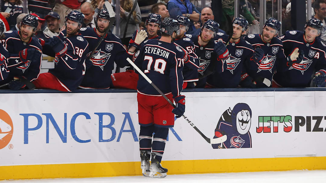 Damon Severson celebrates with the Blue Jackets bench after scoring a goal
