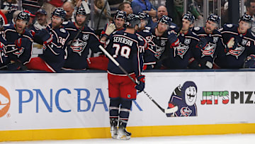 Damon Severson celebrates with the Blue Jackets bench after scoring a goal
