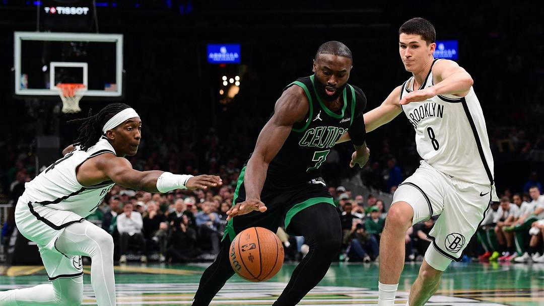 Nov 21, 2025; Boston, Massachusetts, USA; Boston Celtics guard Jaylen Brown (7) controls the ball between Brooklyn Nets guard Terance Mann (14) and guard Egor Demin (8) during the second half at TD Garden. Mandatory Credit: Bob DeChiara-Imagn Images