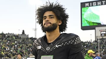 Nov 22, 2025; Eugene, Oregon, USA; Oregon Ducks quarterback Dante Moore (5) walks off the field after the game against the Southern California Trojans at Autzen Stadium. Mandatory Credit: Troy Wayrynen-Imagn Images