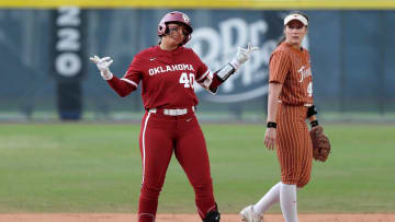 Oklahoma's Alynah Torres (40) gestures next to Texas' Leighann Goode (43) after reaching second base during the Big 12 Tournament championship game on May 11, 2024.