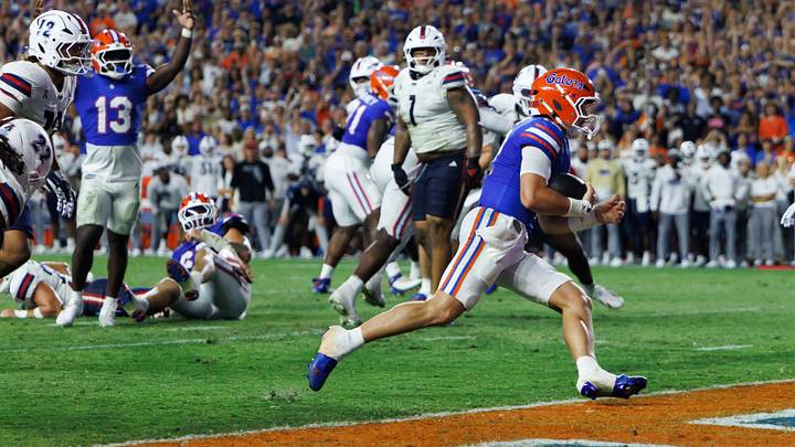 Sep 5, 2026; Gainesville, Florida, USA;  Florida Gators quarterback Aaron Philo (12) rushes for a touchdown against the Florida Atlantic Owls during the first half at Ben Hill Griffin Stadium.  Mandatory Credit: Matt Pendleton-Imagn Images