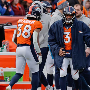 Dec 31, 2023; Denver, Colorado, USA; Denver Broncos quarterback Russell Wilson (3) reacts with running back Jaleel McLaughlin (38) after a play in the second quarter against the Los Angeles Chargers at Empower Field at Mile High. Mandatory Credit: Isaiah J. Downing-USA TODAY Sports