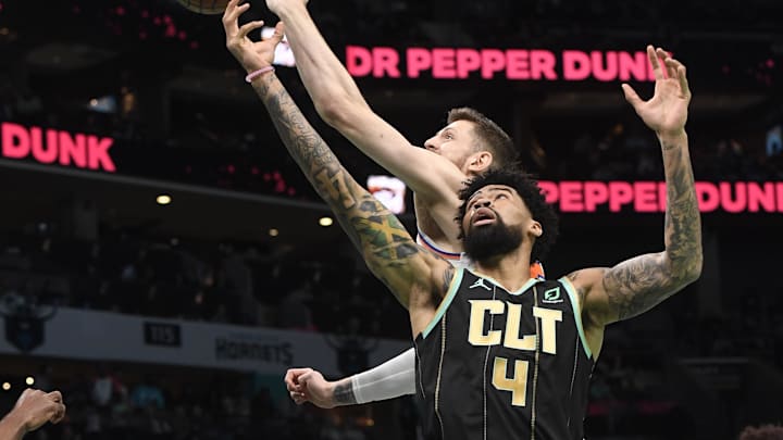 Dec 9, 2022; Charlotte, North Carolina, USA;  Charlotte Hornets center Nick Richards (4) and New York Knicks center Isaiah Hartenstein (55) fight for a rebound during the first half at the Spectrum Center. Mandatory Credit: Sam Sharpe-Imagn Images