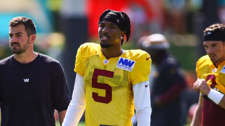 Aug 15, 2024; Miami Gardens, FL, USA; Washington Commanders quarterback Jayden Daniels (5) looks on during joint practice with the Miami Dolphins at Baptist Health Training Complex. Mandatory Credit: Sam Navarro-USA TODAY Sports