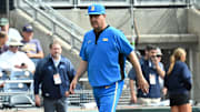 Jun 17, 2025; Omaha, Neb, USA;  UCLA Bruins head coach John Savage (22) walks to the dugout before the restart of the game against the LSU Tigers at Charles Schwab Field. Mandatory Credit: Steven Branscombe-Imagn Images