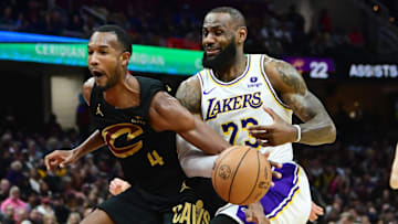 Nov 25, 2023; Cleveland, Ohio, USA; Cleveland Cavaliers forward Evan Mobley (4) fouls Los Angeles Lakers forward LeBron James (23) during the second half at Rocket Mortgage FieldHouse. Mandatory Credit: Ken Blaze-Imagn Images