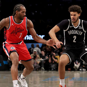 Mar 28, 2025; Brooklyn, New York, USA; Brooklyn Nets forward Cameron Johnson (2) controls the ball against Los Angeles Clippers forward Kawhi Leonard (2) during the third quarter at Barclays Center. Mandatory Credit: Brad Penner-Imagn Images