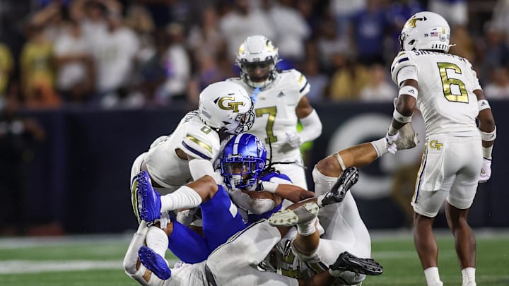 Aug 31, 2024; Atlanta, Georgia, USA; Georgia State Panthers wide receiver Cadarrius Thompson (5) is tackled by Georgia Tech Yellow Jackets linebacker Trenilyas Tatum (0) and defensive back Clayton Powell-Lee (5) in the third quarter at Bobby Dodd Stadium at Hyundai Field. Mandatory Credit: Brett Davis-Imagn Images