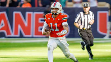 Nov 8, 2025; Miami Gardens, Florida, USA; Miami Hurricanes quarterback Carson Beck (11) rushes the ball against the Syracuse Orange during the first quarter at Hard Rock Stadium. Mandatory Credit: Jeff Romance-Imagn Images
