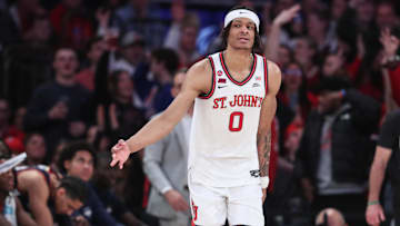 Feb 23, 2025; New York, New York, USA;  St. John's Red Storm guard Aaron Scott (0) reacts after making a three point shot in the first half against the Connecticut Huskies at Madison Square Garden.