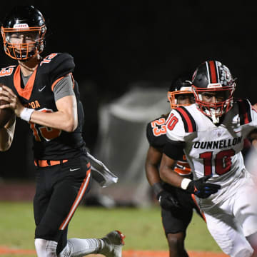 Cocoa QB Brady Hart rolls away from the Dunnellon defense to pass during their game in the FHSAA football playoffs Friday, November 17, 2023. Craig Bailey/FLORIDA TODAY via USA TODAY NETWORK