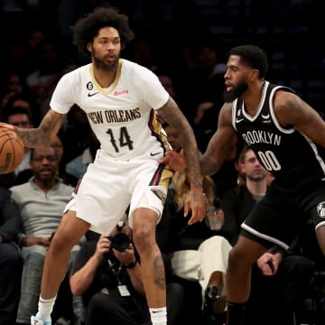 Oct 19, 2022; Brooklyn, New York, USA; New Orleans Pelicans forward Brandon Ingram (14) controls the ball against Brooklyn Nets forward Royce O'Neale (00) during the second quarter at Barclays Center. Mandatory Credit: Brad Penner-USA TODAY Sports