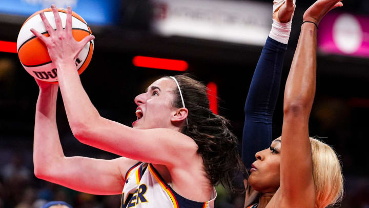 Indiana Fever guard Caitlin Clark (22) goes up for a shot against Connecticut Sun guard DiJonai Carrington (21) on Wednesday, Aug. 28, 2024.