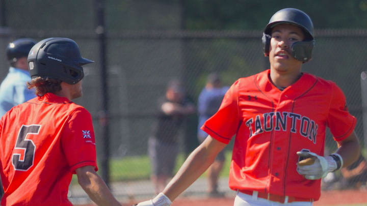 Taunton's Dwayne Burgo (right) high fives Andrew Cali after scoring a run during an MIAA Division 1 Round of 32 game against Whittier Tech.