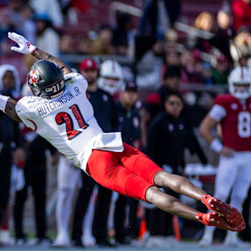Nov 16, 2024; Stanford, California, USA;  Louisville Cardinals defensive back D'Angelo Hutchinson (21) attempts to deflect a pass to Stanford Cardinal wide receiver Emmett Mosley V (10) during the first quarter at Stanford Stadium. Mandatory Credit: Bob Kupbens-Imagn Images