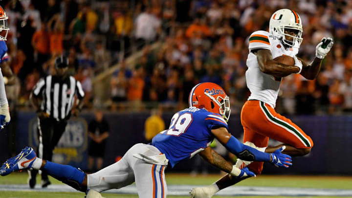 Aug 24, 2019; Orlando, FL, USA; Florida Gators defensive back Jeawon Taylor (29) attempts to bring down Miami Hurricanes wide receiver Mike Harley (3) during the second half at Camping World Stadium. Mandatory Credit: Jasen Vinlove-USA TODAY Sports