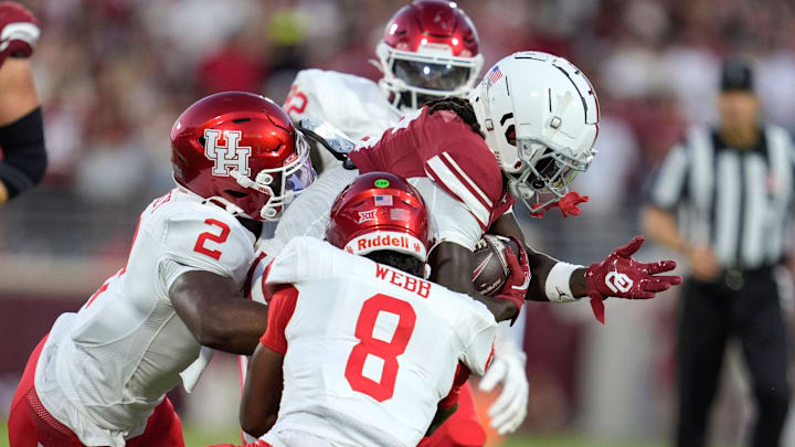 Oklahoma Sooners wide receiver Deion Burks (6) is brought down by Houston Cougars defensive back A.J. Haulcy (2) and defensive back Kentrell Webb (8) after a reception during a college football game between the University of Oklahoma Sooners (OU) and the Houston Cougars at Gaylord Family – Oklahoma Memorial Stadium in Norman, Okla., Saturday, Sept. 7, 2024.