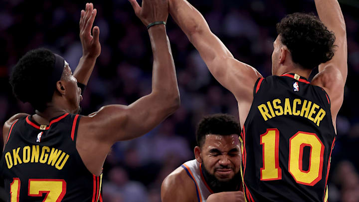 Zaccharie Risacher and Onyeka Okongwu smother Karl Anthony-Towns on a drive to the rim 