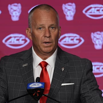 Jul 25, 2024; Charlotte, NC, USA;  North Carolina State Wolfpack head coach Dave Doeren speaks to the media during the ACC Kickoff at Hilton Charlotte Uptown. Mandatory Credit: Jim Dedmon-Imagn Images
