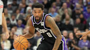Dec 26, 2024; Sacramento, California, USA; Sacramento Kings guard Malik Monk (0) controls the ball against Detroit Pistons guard Jaden Ivey (23) during the fourth quarter at Golden 1 Center. Mandatory Credit: Kelley L Cox-Imagn Images