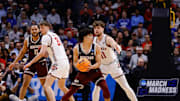 Mar 20, 2025; Denver, CO, USA; Wisconsin Badgers guard Max Klesmit (11) defends against Montana Grizzlies guard Malik Moore (3) during the first half in the first round of the NCAA Tournament at Ball Arena. Mandatory Credit: Isaiah J. Downing-Imagn Images