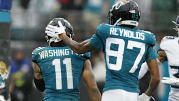 Dec 29, 2024; Jacksonville, Florida, USA; Jacksonville Jaguars wide receiver Parker Washington (11) and wide receiver Josh Reynolds (87) celebrate a touchdown against the Tennessee Titans during the second quarter at EverBank Stadium. Mandatory Credit: Morgan Tencza-Imagn Images