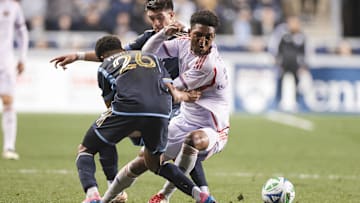 Apr 5, 2025; Chester, Pennsylvania, USA; Orlando City SC defender Alex Freeman (30) dribbles the ball against Philadelphia Union defender Nathan Harriel (26) during the second half at Subaru Park. Mandatory Credit: Luther Schlaifer-Imagn Images