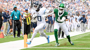 Sep 15, 2024; Nashville, Tennessee, USA;  Tennessee Titans wide receiver Calvin Ridley (0) scores past New York Jets cornerback Sauce Gardner (1) during the first half at Nissan Stadium. Mandatory Credit: Steve Roberts-Imagn Images