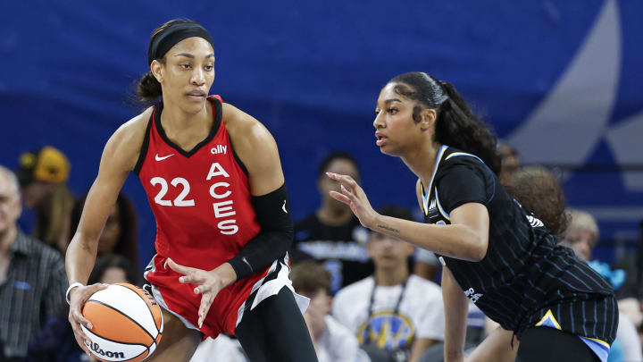 Aug 25, 2024; Chicago, Illinois, USA; Las Vegas Aces center A'ja Wilson (22) is defended by Chicago Sky forward Angel Reese (5).