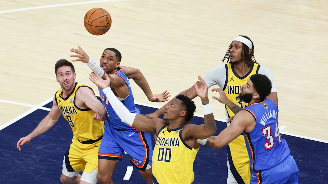 Jun 19, 2025; Indianapolis, Indiana, USA; Oklahoma City Thunder guard Aaron Wiggins (21) goes after a loose ball against Indiana Pacers guard T.J. McConnell (9) and guard Bennedict Mathurin (00) in the fourth quarter during game six of the 2025 NBA Finals at Gainbridge Fieldhouse. Mandatory Credit: Trevor Ruszkowski-Imagn Images