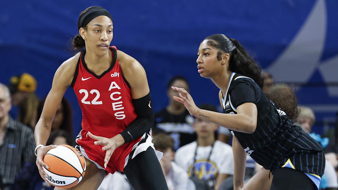 Aug 25, 2024; Chicago, Illinois, USA; Las Vegas Aces center A'ja Wilson (22) is defended by Chicago Sky forward Angel Reese (5) during the first half at Wintrust Arena. Mandatory Credit: Kamil Krzaczynski-Imagn Images