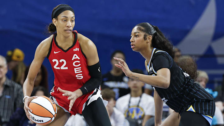 Aug 25, 2024; Chicago, Illinois, USA; Las Vegas Aces center A'ja Wilson (22) is defended by Chicago Sky forward Angel Reese (5) during the first half at Wintrust Arena. Mandatory Credit: Kamil Krzaczynski-Imagn Images