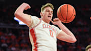 Mar 8, 2025; Clemson, SC, USA;  Clemson senior center Viktor Lakhin (0) dunks near Virginia Tech forward Ben Burnham (13)  during the first half at Littlejohn Coliseum in Clemson, S.C Saturday, March 8, 2025.