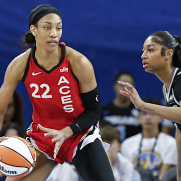 Aug 25, 2024; Chicago, Illinois, USA; Las Vegas Aces center A'ja Wilson (22) is defended by Chicago Sky forward Angel Reese (5) during the first half at Wintrust Arena. Mandatory Credit: Kamil Krzaczynski-Imagn Images